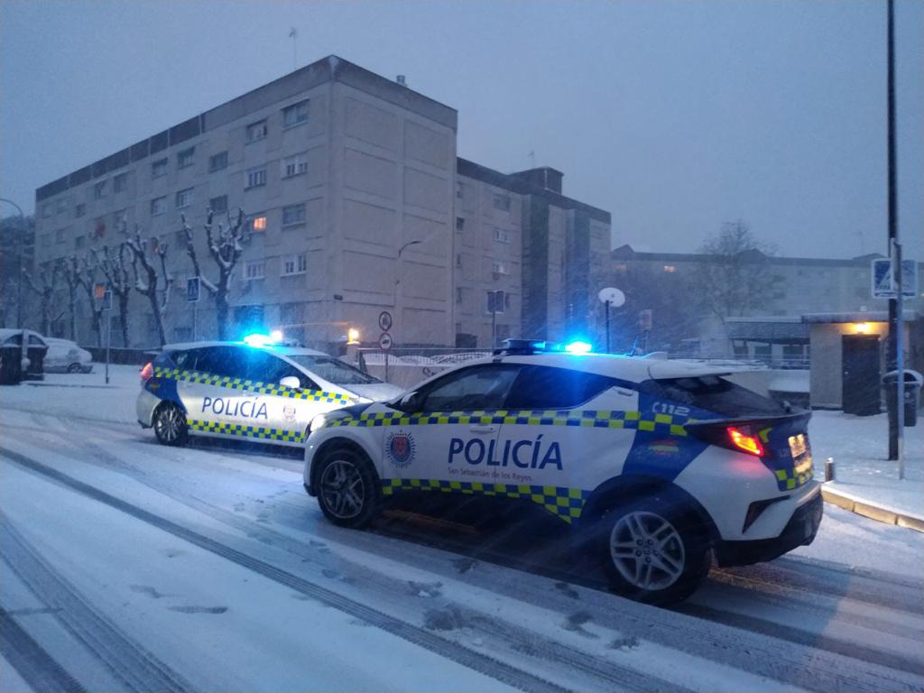 Dos coches patrulla de la Policía, durante el temporal de nieve.